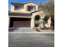 Two-story house with brown garage door and landscaping at 8178 Rock Meadows Dr, Las Vegas, NV 89178