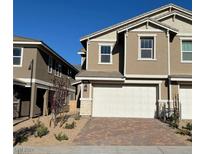 Two story home with a two-car garage and landscaping at 740 Monroe Hill Pl, Henderson, NV 89011