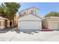 Two-story house with attached garage and landscaping at 4805 Principle Ct, North Las Vegas, NV 89031