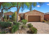 Single story home with a two-car garage and well-manicured landscaping at 6 Lago Turchino Ct, Henderson, NV 89011