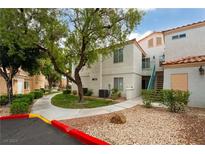 Exterior view of a residential building with landscaping and walkway at 8452 Boseck Dr # 287, Las Vegas, NV 89145
