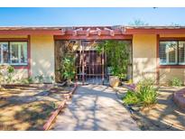 Charming ranch home with a gated entryway and landscaped walkway at 5410 Manteca Cir, Las Vegas, NV 89118