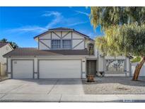 Two-story house with three-car garage and landscaped yard at 2101 Autumn Lull Dr, Las Vegas, NV 89146