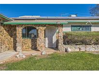 Charming ranch-style home with stone facade and landscaped yard at 408 Rossmoyne Ave, North Las Vegas, NV 89030