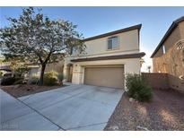 Two-story house with tan exterior, attached garage, and landscaping at 8205 Celina Hills St, Las Vegas, NV 89131