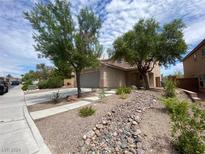 Two-story house with a landscaped front yard and attached garage at 2604 Courlan Dr, North Las Vegas, NV 89084