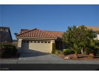 Single-story home with tile roof, attached garage, and desert landscaping at 8208 Bermuda Beach Dr, Las Vegas, NV 89128