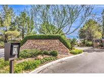 Inviting community entrance with stonework and landscaping at 10909 Bramante Dr, Las Vegas, NV 89141