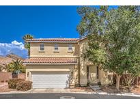 Two-story home with beige exterior and white garage door at 3241 Rainmaker St, Las Vegas, NV 89129