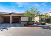 Tan two-car garage home with a landscaped front yard at 7455 Brody Meadows St # 0, North Las Vegas, NV 89084