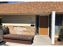 Front view of a single story home with a brown door and stone accents at 2639 Heritage Dr, Las Vegas, NV 89121
