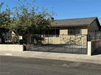 Single story home with gated driveway and landscaping at 2309 Constantine Ave, Las Vegas, NV 89101