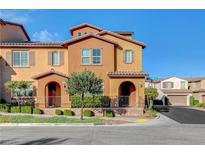 Two-story townhome with a charming facade and landscaped front yard at 11420 Ogden Mills Dr # 101, Las Vegas, NV 89135