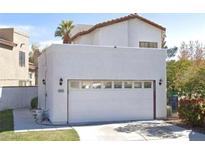 Two story house with a white garage door and landscaping at 6645 Telegraph Rd, Las Vegas, NV 89108