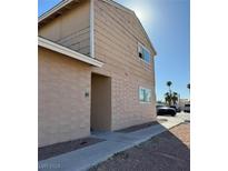 Tan two-story building with parking and walkway at 5116 Gray Ln # H, Las Vegas, NV 89119