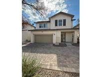 Two-story house with a tan garage door at 927 Sunny Acres Ave, North Las Vegas, NV 89081