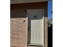 Exterior view of a building's entrance with a light fixture above the door at 5116 Gray Ln # F, Las Vegas, NV 89119