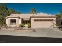 Single-story home with beige exterior, tile roof, and attached garage at 10920 Black Ledge Ave, Las Vegas, NV 89134