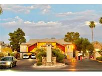 Community entrance with gated access and building exterior visible at night at 2700 N Rainbow Blvd # 2097, Las Vegas, NV 89108