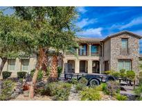 Two-story house with stone facade, balcony, and landscaping at 3995 Heldron St, Las Vegas, NV 89121