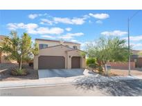 Two-story house with a two-car garage and landscaping at 6728 Towerstone St, North Las Vegas, NV 89084