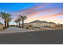 Single-story home with desert landscaping and a paved driveway at 6615 Whispering Sands Dr, Las Vegas, NV 89131