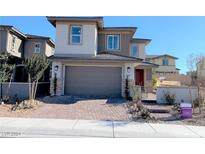 Two story house with gray siding and two car garage at 107 Orchestral Ln, Henderson, NV 89011