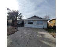Single story home with a driveway and mature trees at 309 Rossmoyne Ave, North Las Vegas, NV 89030