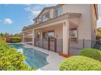 Inviting backyard oasis featuring a sparkling pool, expansive patio, and lush landscaping at 612 El Loro St, Las Vegas, NV 89138