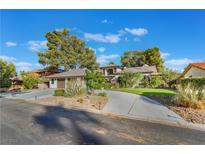 House exterior with three-car garage and landscaped yard at 2504 Windjammer Way, Las Vegas, NV 89107