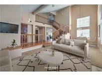 Virtually staged living room with high ceilings and a view of the staircase at 2244 Brighton Shore St, Las Vegas, NV 89128