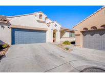 Two-story house with gray garage door and desert landscaping at 9353 Borough Park St, Las Vegas, NV 89178