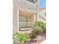 Private patio with sliding glass door and landscaping at 601 Harvest Run Dr # 102, Las Vegas, NV 89145