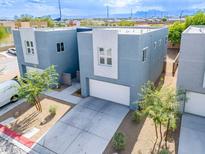 Modern two-story townhouses with attached garages, neatly landscaped yards, and mountain views at 6455 Cinnamon Hazelnut St, North Las Vegas, NV 89084