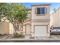 Two-story house with attached garage and landscaping at 9980 Swimming Hole St, Las Vegas, NV 89183