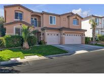 Two-story house with beige exterior, three-car garage, and manicured lawn at 10105 Shore Pine Ave, Las Vegas, NV 89129