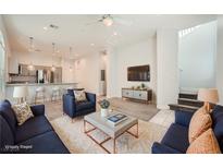 Open concept living room with modern furniture and kitchen at 6440 Spring Jog St, Las Vegas, NV 89166