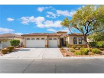 Single-story home with three-car garage and landscaped front yard at 5919 Karnes Ranch Ave, Las Vegas, NV 89131