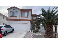 Two-story house with attached garage and desert landscaping at 5835 Rainbow Trout Ct, Las Vegas, NV 89113