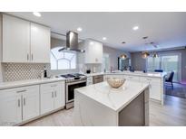 Modern kitchen with white cabinets, quartz counters, and island at 4211 Saxton Green Ave, Las Vegas, NV 89141