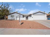 Ranch style home with gray siding and a two car garage at 4010 E Twain Ave, Las Vegas, NV 89121
