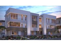 Modern three-story townhome building with attractive landscaping at 667 Agate Bridge St, Las Vegas, NV 89138