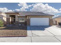 Single story home with a two-car garage and gravel landscaping at 3630 Newton Falls St, North Las Vegas, NV 89032