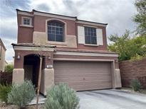 Two-story home with attached garage and landscaping at 7961 Alta Lima Valley Ct, Las Vegas, NV 89178