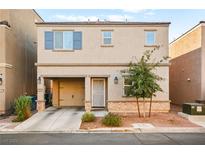 Two-story home with attached garage and small front yard at 2461 Creeping Rosemary Ct, Las Vegas, NV 89115