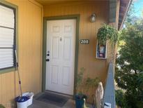 Front door entrance with potted plants at 5158 S Jones Blvd # 208, Las Vegas, NV 89118