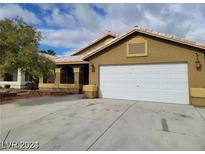 Single story house with white garage door at 4406 Cinema Ave, North Las Vegas, NV 89031
