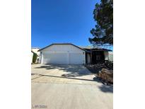 Three-car garage with white doors at 321 Bent Creek Dr, Las Vegas, NV 89107