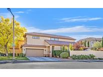 Two-story house with attached garage, landscaping, and a driveway at 9329 Eagle Ridge Dr, Las Vegas, NV 89134