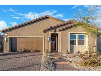 Single story home with brown garage door and landscaping at 3022 Risen Star Rd, North Las Vegas, NV 89086